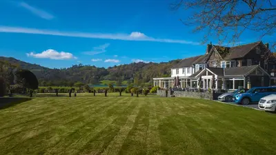 a large house with a green lawn in front of it at The Grand at Grasmere in Grasmere