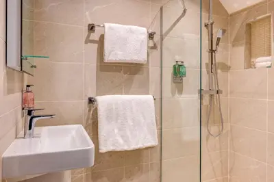 a bathroom with a sink and a shower at The Grand at Grasmere in Grasmere