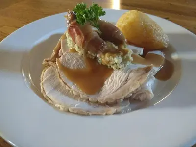 a white plate with a piece of food on it at The Old Ginn House Inn in Great Clifton