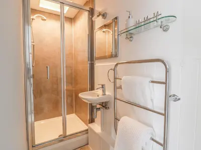 a bathroom with a shower and a sink at Marsh Villa in Skinburness