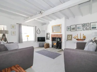 a living room with a couch and a fireplace at Marsh Villa in Skinburness