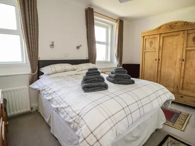 a bedroom with a bed with towels on it at Coombs View in Low Hesket