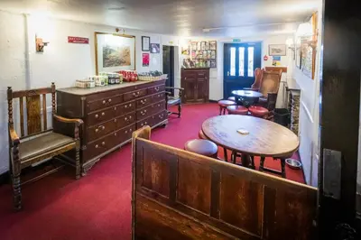 a room with a table and a desk and a table at The Britannia Inn in Elterwater