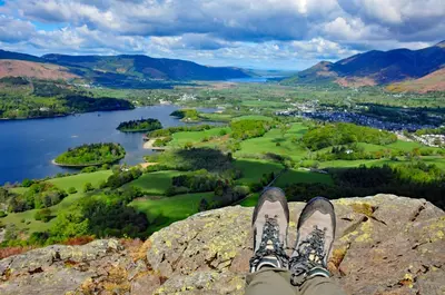 a person with their feet up on a rock overlooking a lake at Abacourt House in Keswick