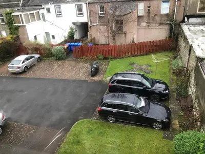 two cars parked in a driveway in a yard at Ailsa Retreat in Troon