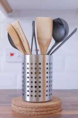 a metal container filled with wooden utensils on a table at Ailsa Retreat in Troon