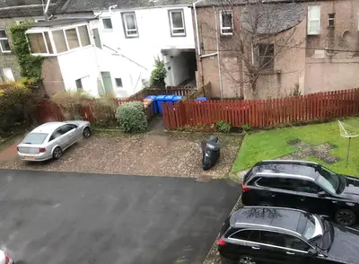 two cars parked in a driveway in front of a house at Ailsa Retreat in Troon