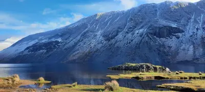 a mountain reflecting in a body of water at Strands Hotel/Screes Inn & Micro Brewery in Nether Wasdale