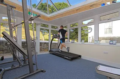 a man running on a treadmill in a gym at Embleton Spa Hotel & Apartments in Embleton