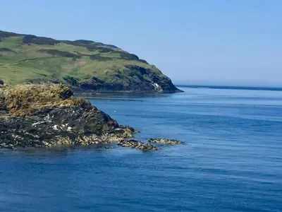 an island in the middle of a body of water at The Stables @ The Forge Cronk Y Voddy in Saint Johns