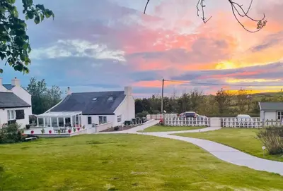 a white house with a lawn and a driveway at The Stables @ The Forge Cronk Y Voddy in Saint Johns
