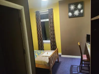 a small room with a chair and a window at The Queensberry Hotel in Dumfries