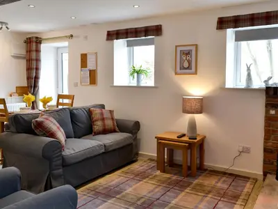 a living room with a couch and a table at Farmhouse Cottage - Uk1285 in Westward