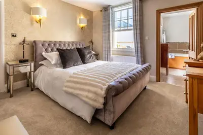 a bedroom with a large bed and a window at Georgian House Hotel in Whitehaven