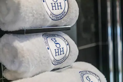 a white teddy bear sitting on a shelf at Georgian House Hotel in Whitehaven