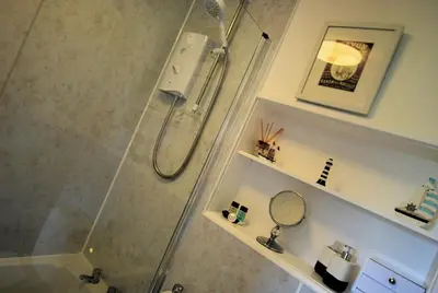 a bathroom with a shower with a glass shower stall at 4 Laigh Isle in Isle of Whithorn