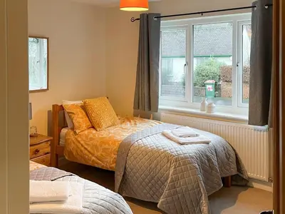 a bedroom with two beds and a window at Briargarth in Keswick