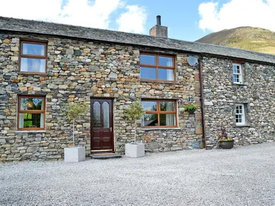 a stone building with a door in front of it at Grajo Cottage - Uk1284 in Threlkeld