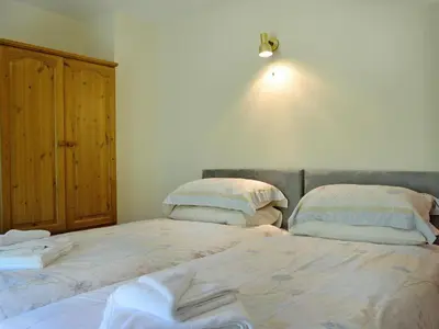 a bedroom with a bed with two pillows on it at Grajo Cottage - Uk1284 in Threlkeld