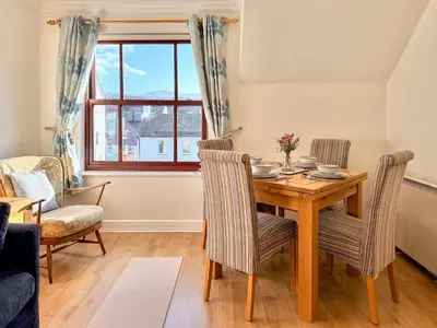 a dining room with a wooden table and chairs at Hindscarth in Keswick