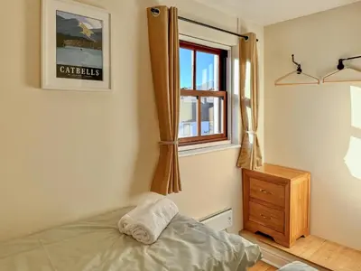 a bedroom with a bed and a window at Hindscarth in Keswick