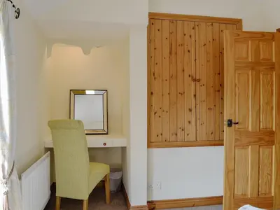 a room with a chair and a mirror and a door at Brackendale Cottage - Uk1335 in Threlkeld