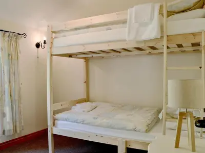a bedroom with two bunk beds and a desk at Brackendale Cottage - Uk1335 in Threlkeld