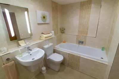 a bathroom with a sink and a toilet and a tub at Lords Seat Bed & Breakfast in Keswick