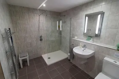 a bathroom with a sink and a shower and a toilet at Lords Seat Bed & Breakfast in Keswick