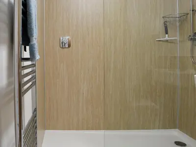a shower with a glass door in a bathroom at Little Cottage in Wigtown