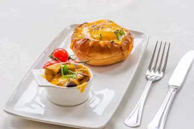 a plate with a pastry and a bowl of food at The Devonian in Douglas