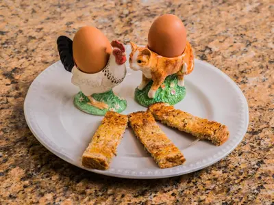 a plate with two eggs and some food on it at The Devonian in Douglas