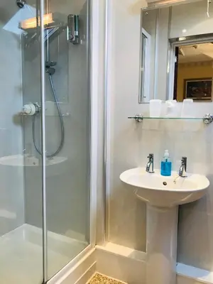 a bathroom with a sink and a shower at Cornerways Guest House in Carlisle