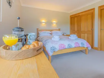 a bedroom with a bed and a bowl of bread at The Potting Shed in Challoch