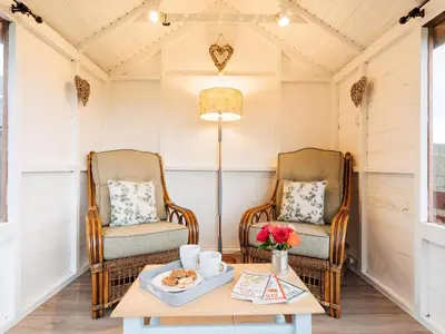 two chairs and a coffee table in a room at The Bothy - Uk5803 in Girthon