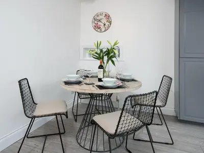 a dining room with a table and chairs at Callander's High Street in Gatehouse of Fleet