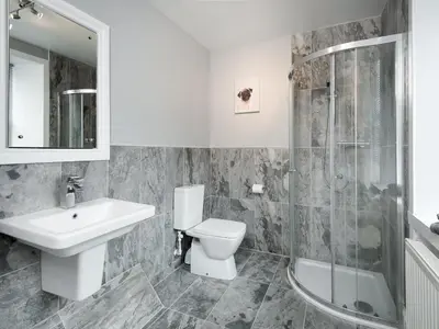a bathroom with a toilet and a sink and a shower at Callander's High Street in Gatehouse of Fleet