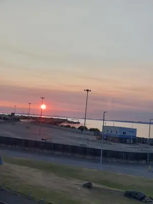 a parking lot with the sunset in the background at The Anchorage in Troon