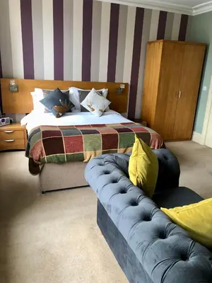 a hotel room with a bed and a couch at Salisbury Guest House in Keswick