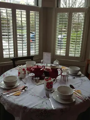 a table with plates and cups and utensils on it at Raymonds in Douglas