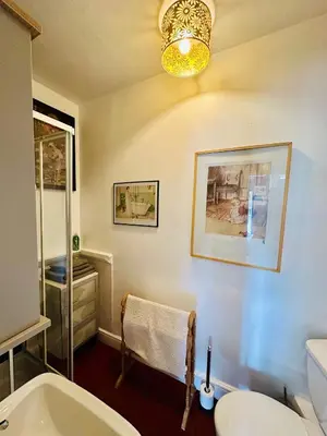 a bathroom with a tub and a toilet and a sink at Fitz House in Keswick