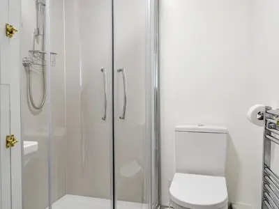 a bathroom with a toilet and a glass shower at Jose's At The Grange in Mockerkin