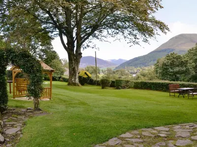 a garden with a gazebo and a tree at Jose's At The Grange in Mockerkin