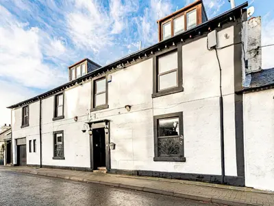 a white building on a street at The Golden Crown in Tarbolton