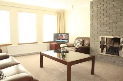 a living room with a couch and a coffee table at Abbots Way in Ayr