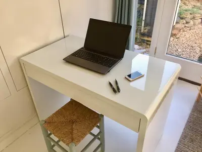 a laptop computer sitting on a white desk at The Retreat Studio in Carlisle