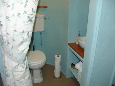 a small bathroom with a toilet and a sink at Osborne House B&B Workington in Workington