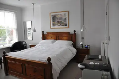 a bedroom with a bed and a desk and a chair at Rooms36 in Keswick