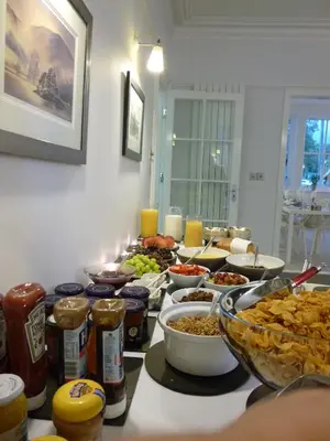a table with many bowls of food on it at Rooms36 in Keswick