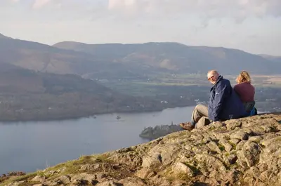 a man and woman sitting on top of a mountain at Rooms36 in Keswick